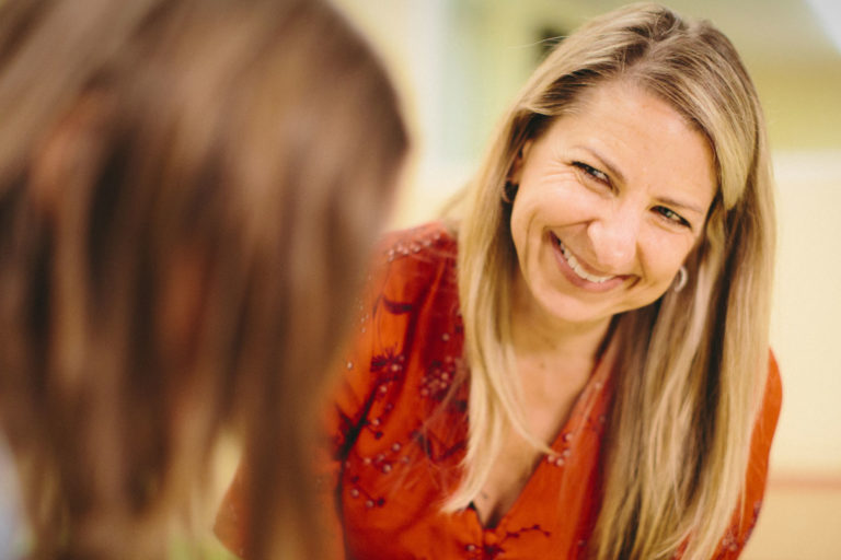 Dr. Caelan Soma smiling with patient