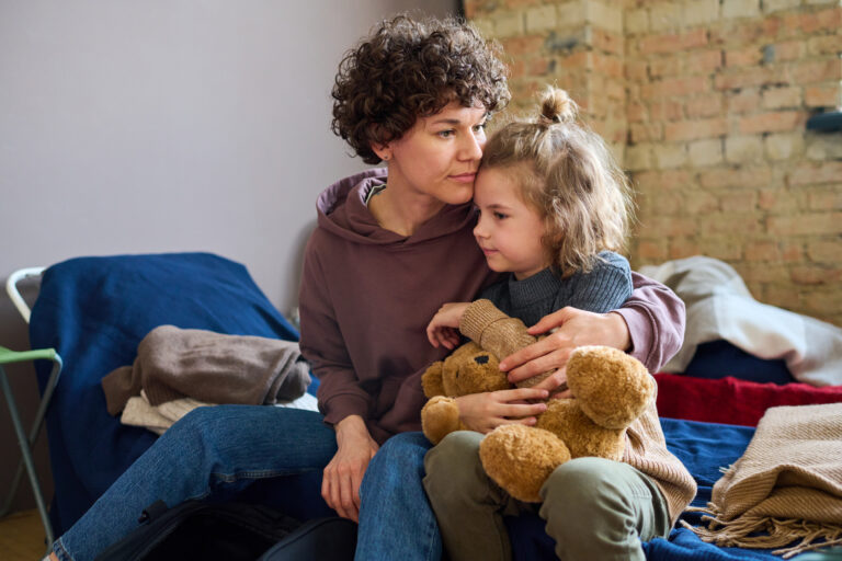 Woman giving hug to child